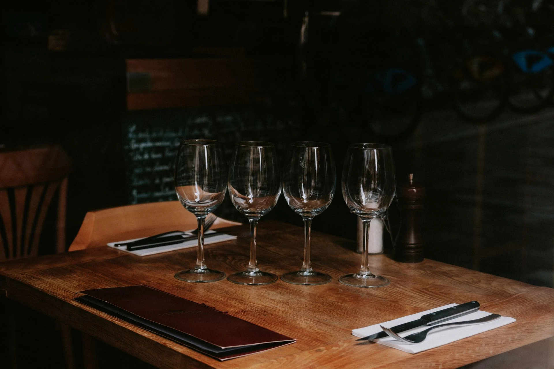 Wine glasses and a considered restaurant table setting; editorial hospitality photograph